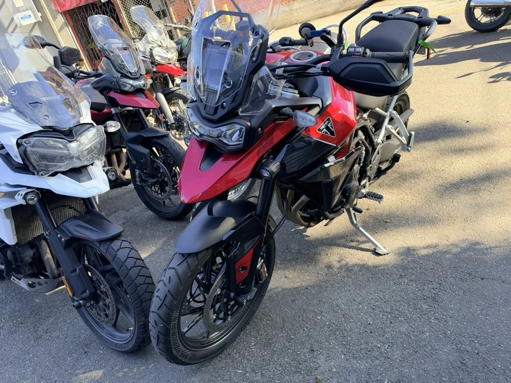 Red Triumph Tiger 900 examined with the owner present